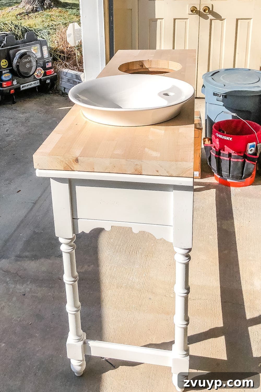 Upgrade Your Console Table to a Stunning Bathroom Vanity 12 Dry fitting vessel sinks into a butcher block countertop on a console table vanity to check alignment.