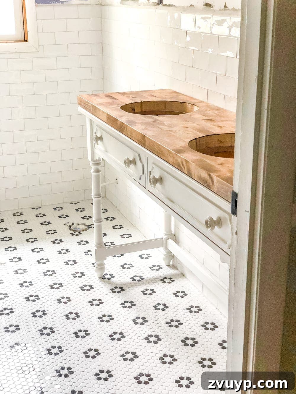 Upgrade Your Console Table to a Stunning Bathroom Vanity 14 Applying clear silicone caulk along the back edge of a newly installed bathroom vanity countertop.