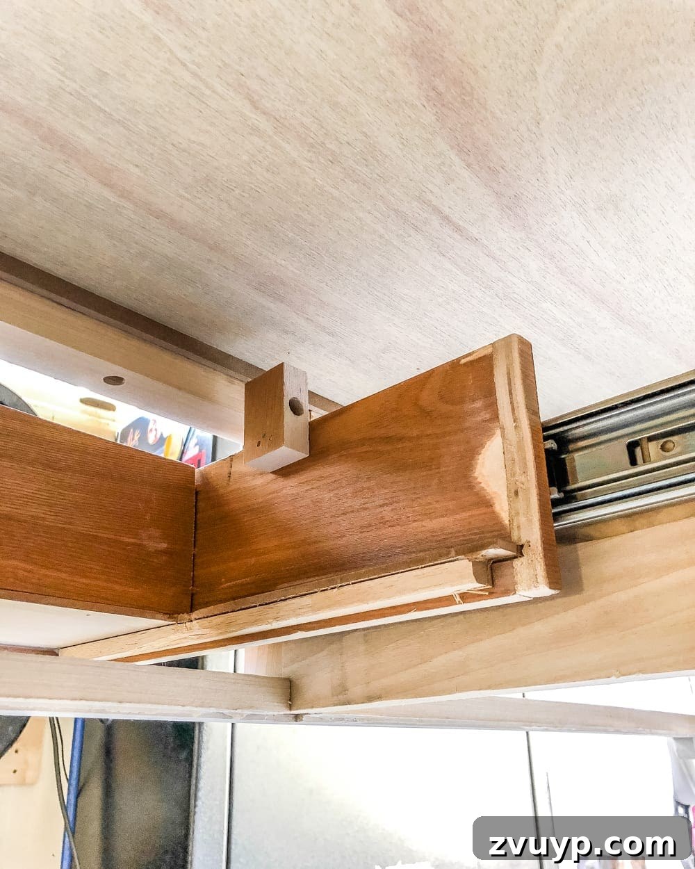 Upgrade Your Console Table to a Stunning Bathroom Vanity 6 Measuring and marking a console table drawer to accommodate sink plumbing for a functional bathroom vanity.