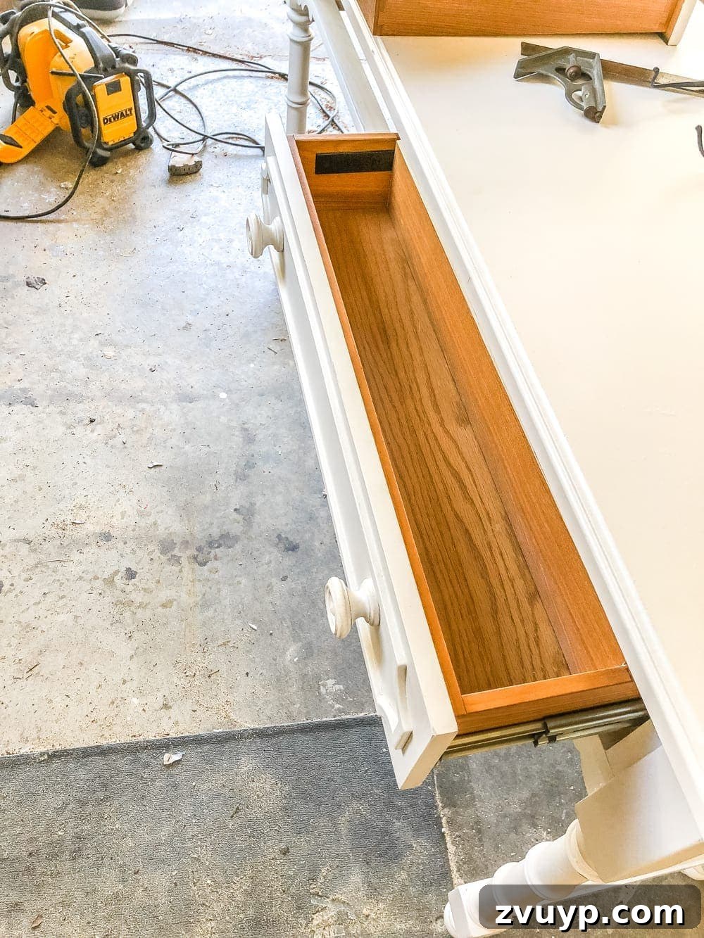 Upgrade Your Console Table to a Stunning Bathroom Vanity 7 Installing a custom drawer stopper made from a wood scrap during console table vanity conversion.