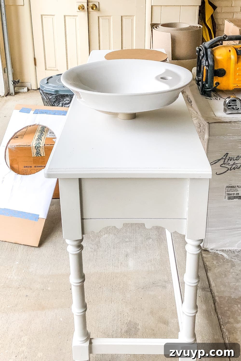 Upgrade Your Console Table to a Stunning Bathroom Vanity 8 Tracing a sink template onto a piece of wood for a DIY bathroom vanity project.