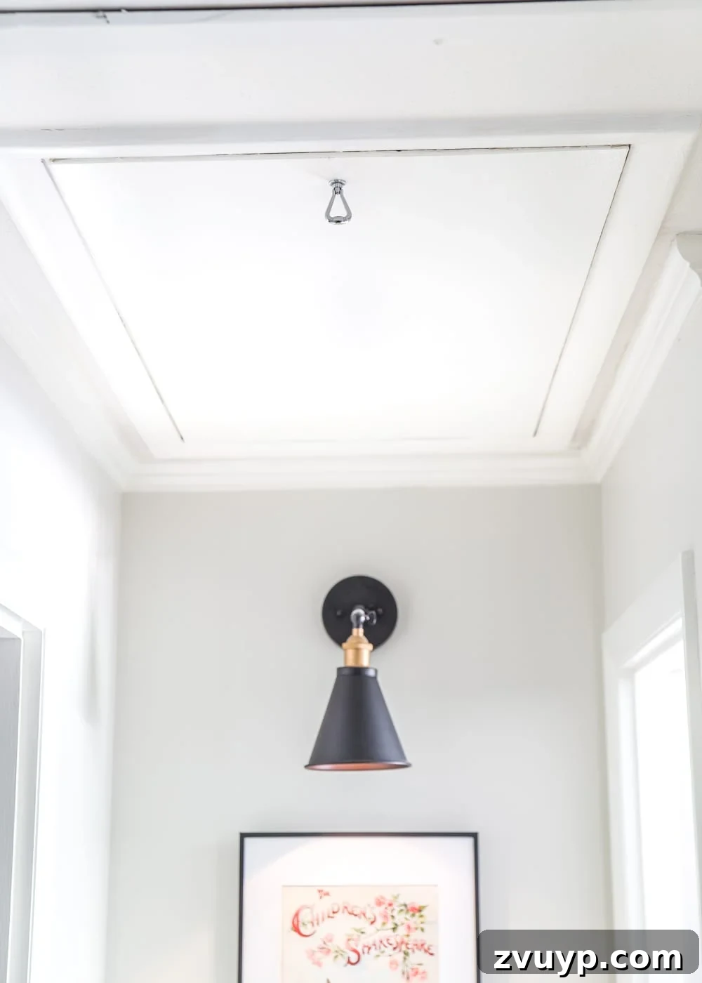 Upgrade Attic Door String to a Hook 7 Beautifully renovated hallway showing a white attic door with only a small, discreet pull ring, no visible string.