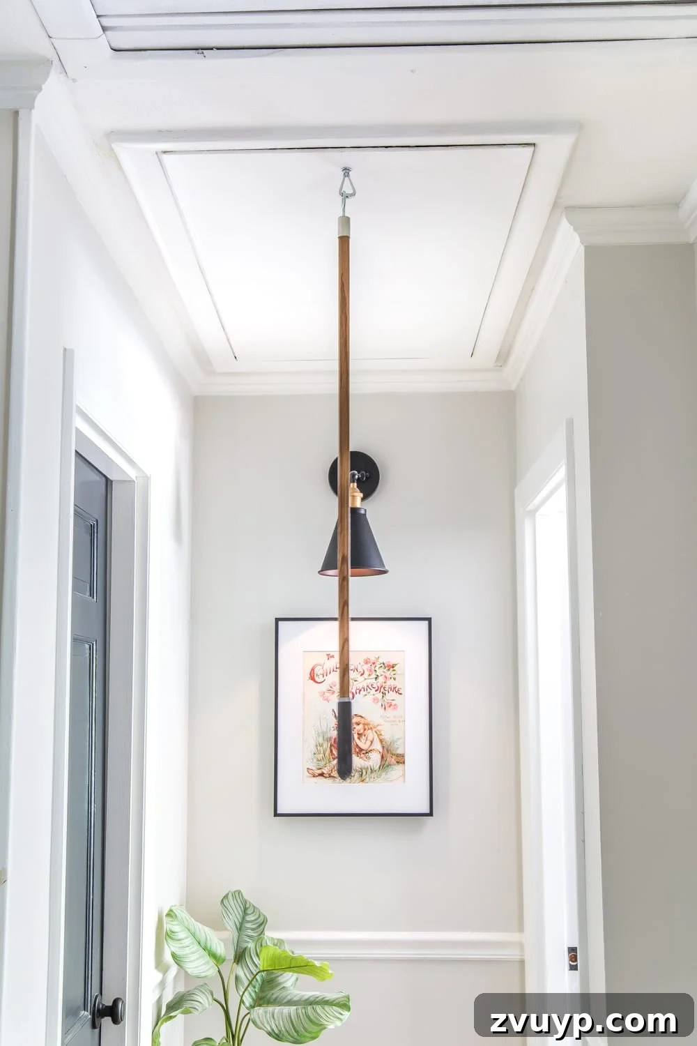 Upgrade Attic Door String to a Hook 8 Specialized pull pole with a hook end for engaging the attic door ring, stored discreetly.