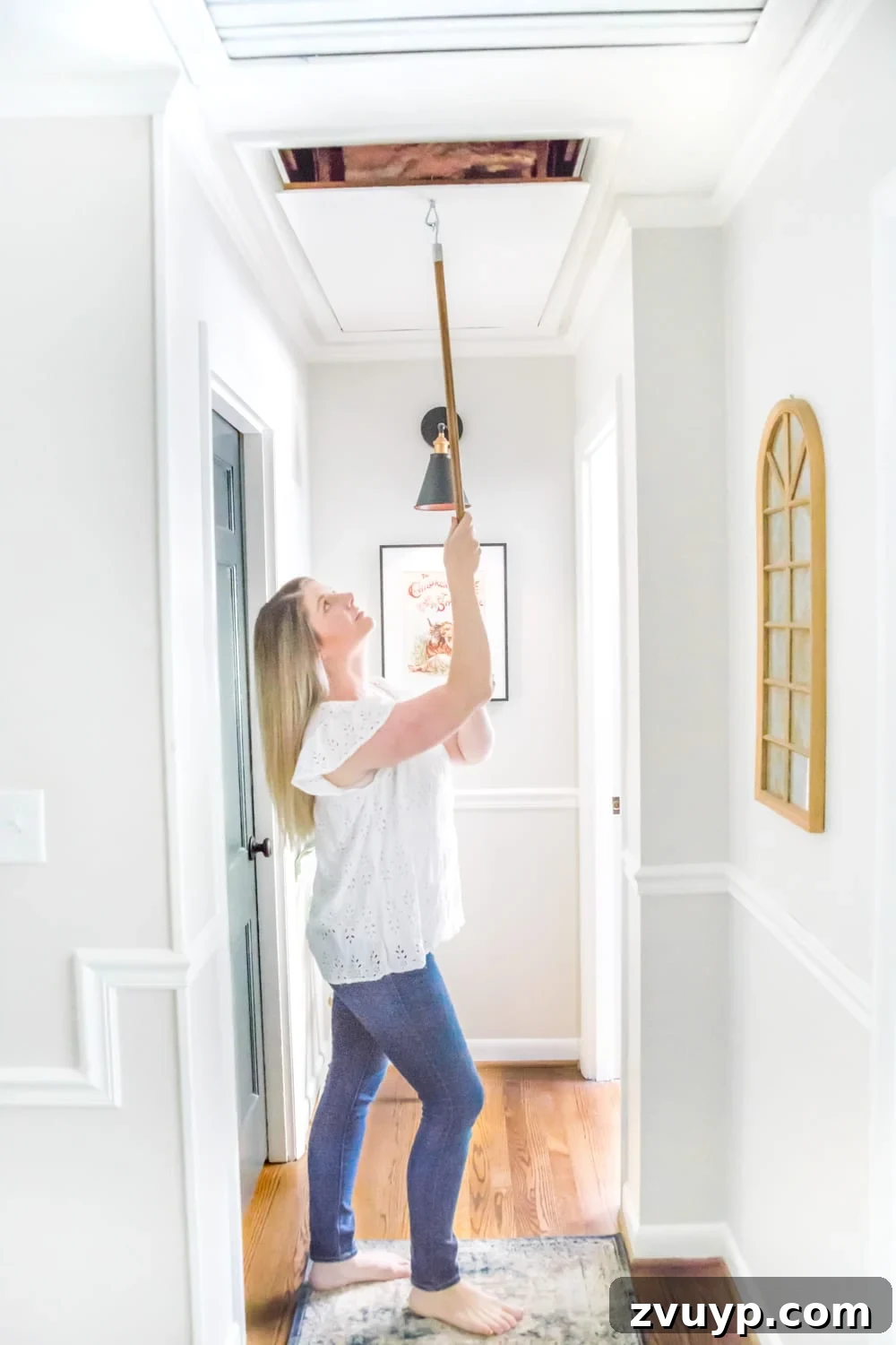 Upgrade Attic Door String to a Hook 9 Bright and airy hallway after renovation, featuring a clean white attic door with a hidden pull mechanism.
