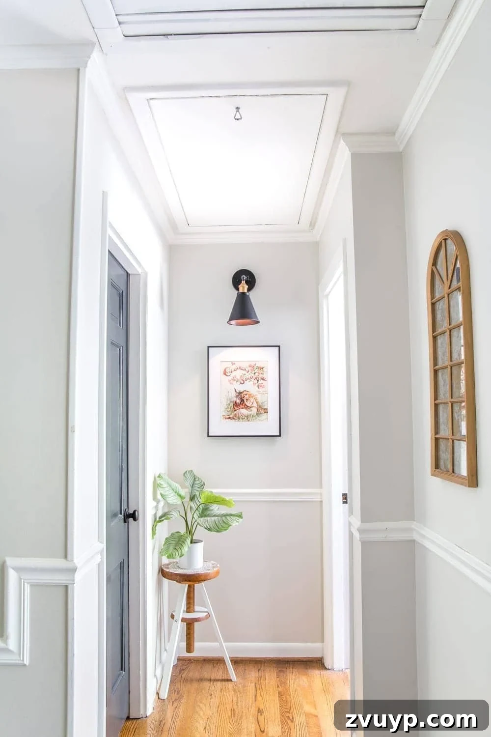 Upgrade Attic Door String to a Hook 10 Full view of a stylish, refreshed hallway, showcasing a discreet attic door that blends into the wall.