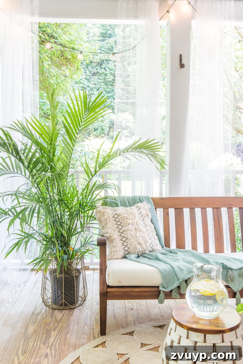 Bohemian Summer Sanctuary 5 A tropical boho back porch featuring a live palm plant in a brass wire basket, styled with Drew Barrymore's Flower Home decor.