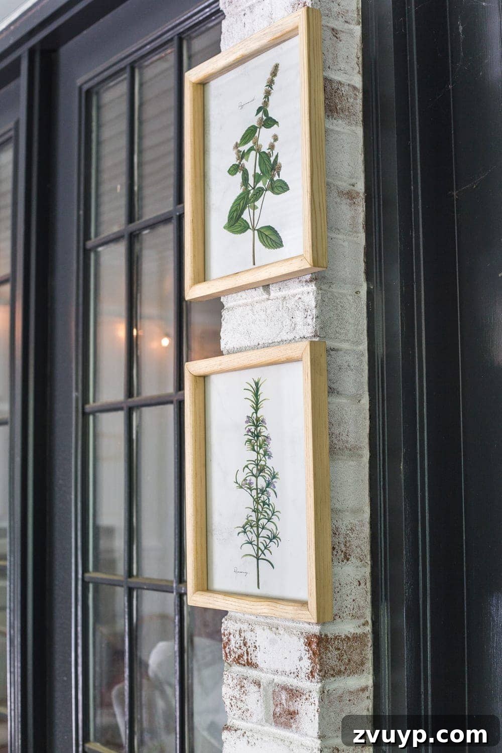 Bohemian Summer Sanctuary 7 Botanical prints hanging on a limewashed brick wall on a tropical boho back porch, styled with summer decor.