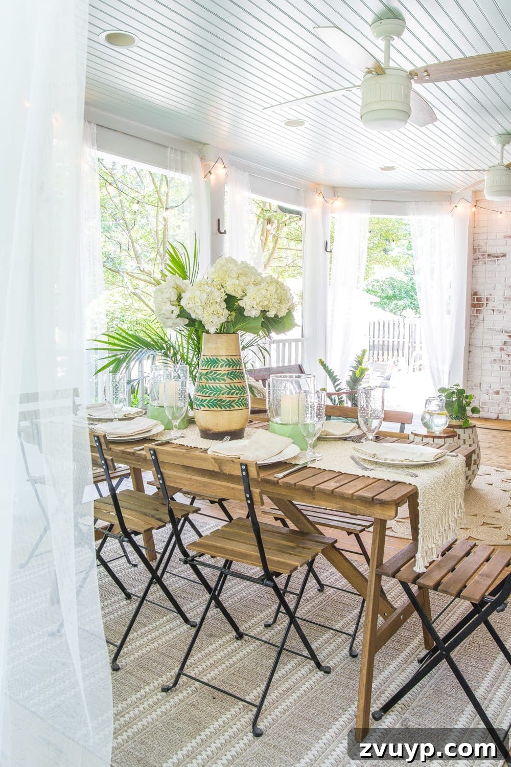 Bohemian Summer Sanctuary 10 An outdoor dining table set with fresh hydrangeas and surrounded by string lights, perfect for al fresco dining on a tropical boho porch.