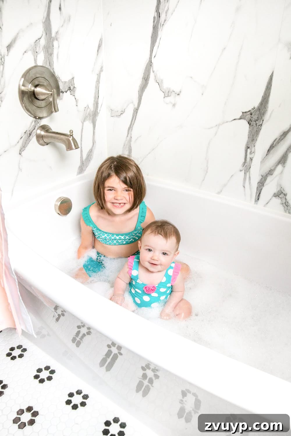 Unveiling the Ultimate Kids Bathroom Makeover 23 Detailed view of faux marble shower walls by American Standard in kids bathroom