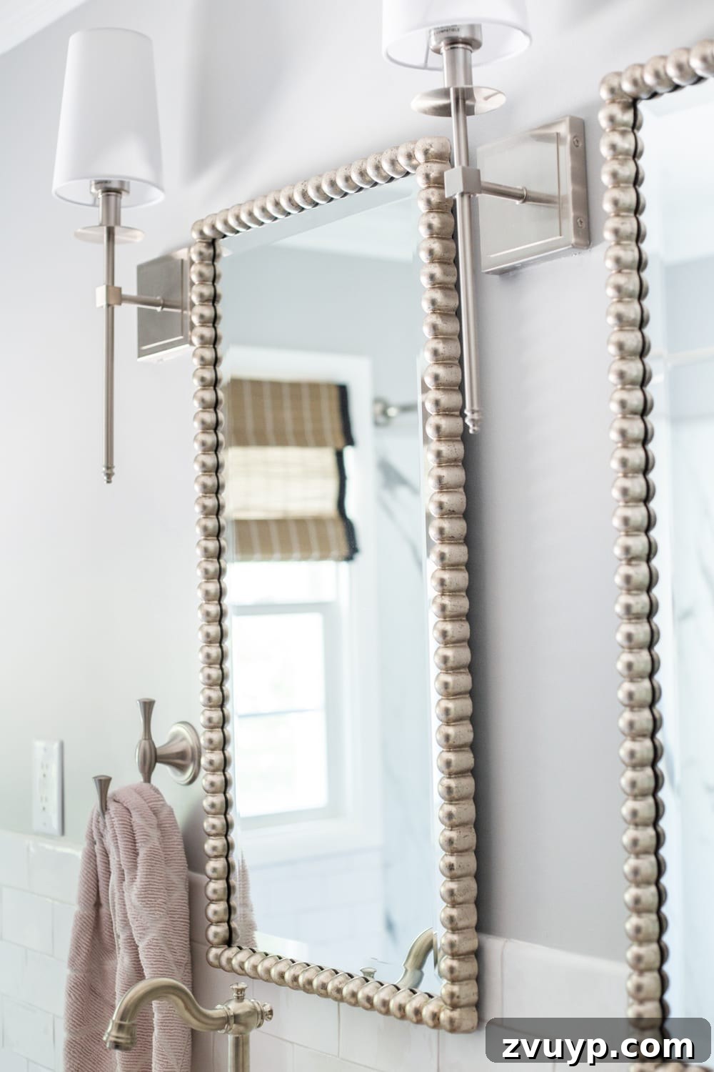 Beaded Mirrors and Shaded Sconces: Elegant brushed nickel details in a classic girls' bathroom