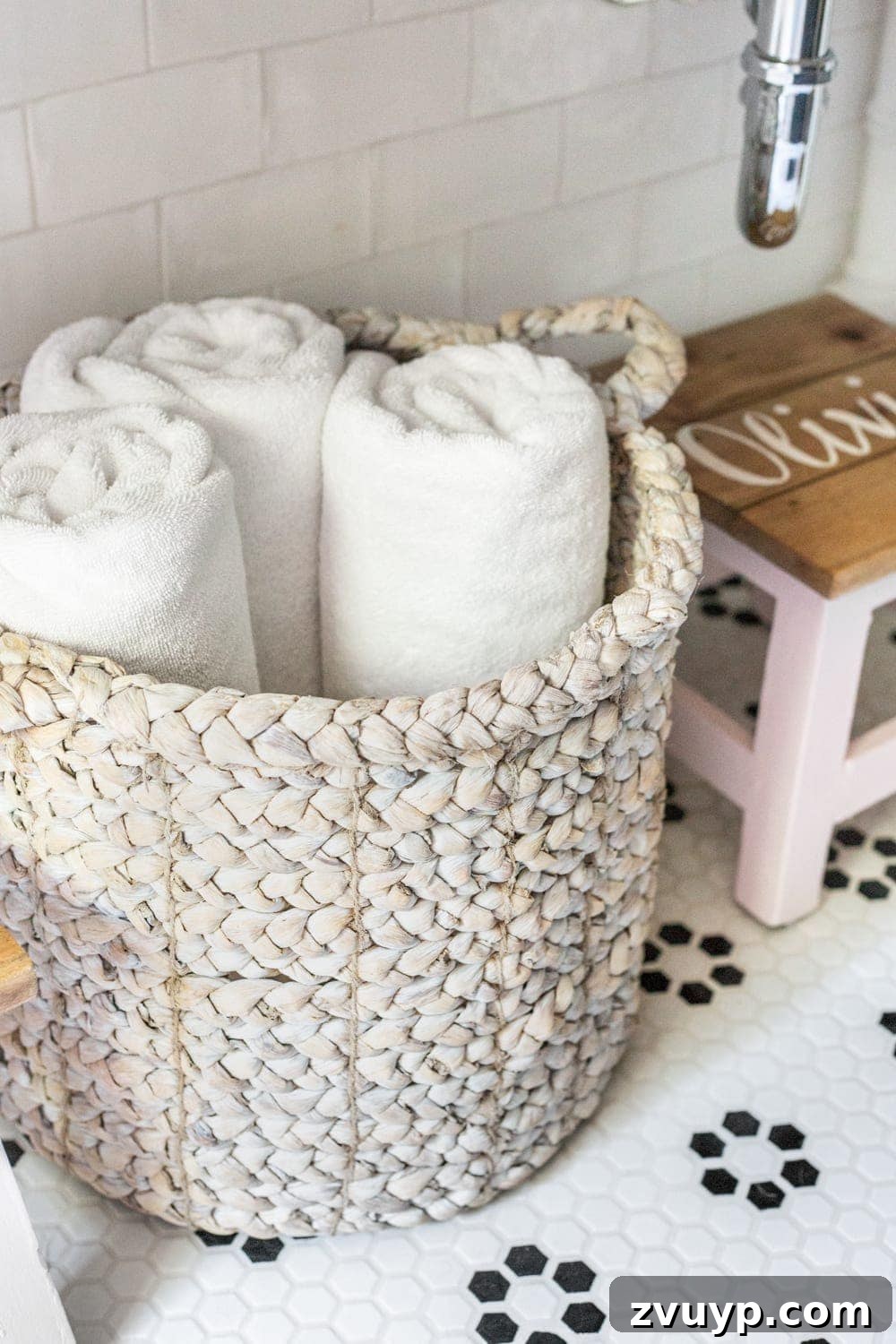 Under Vanity Storage: Woven basket holding towels beneath an open console vanity