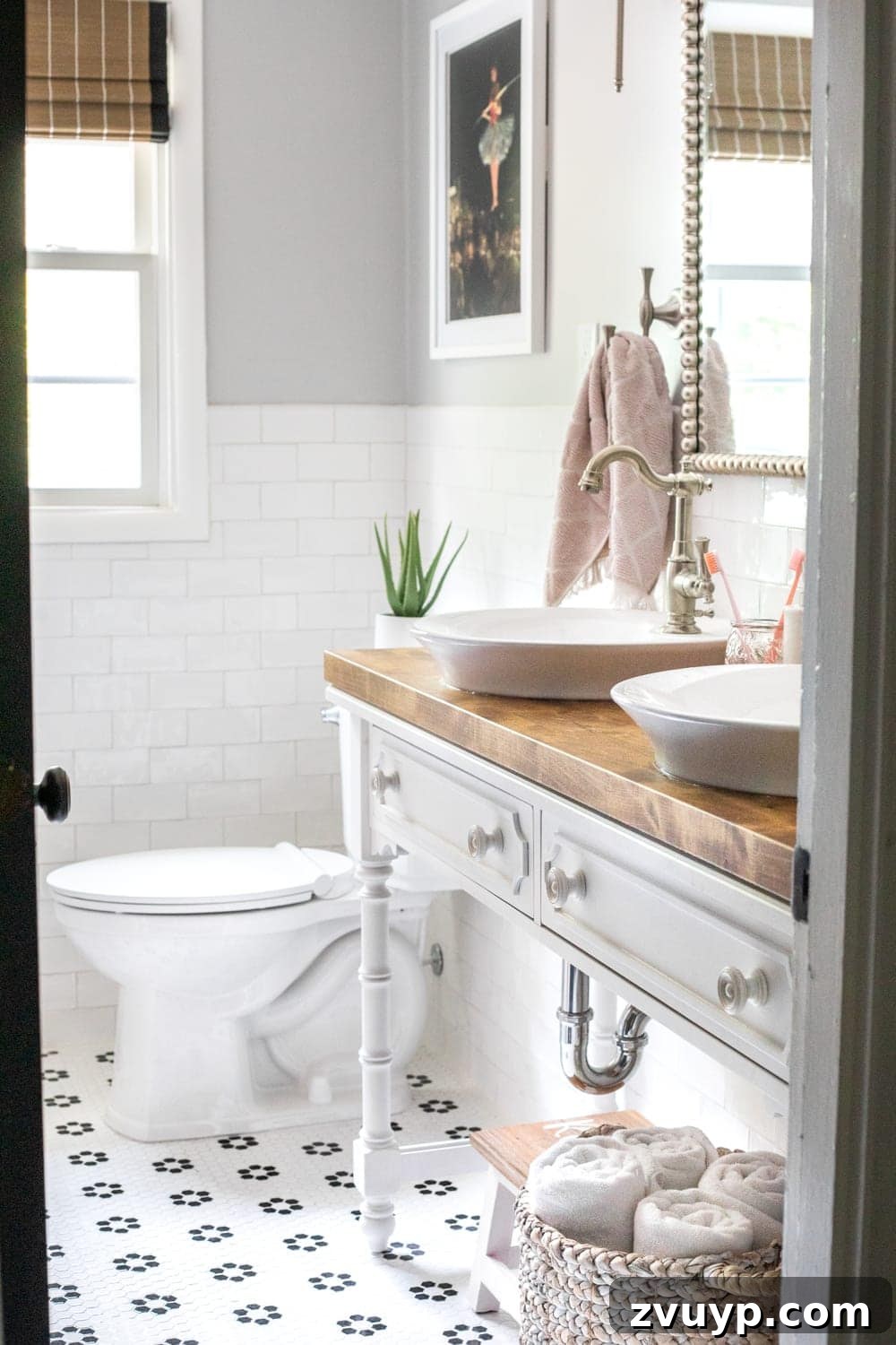 Girly Bathroom Design: Console vanity with vessel sinks, retro flower floor tile, and sophisticated accents