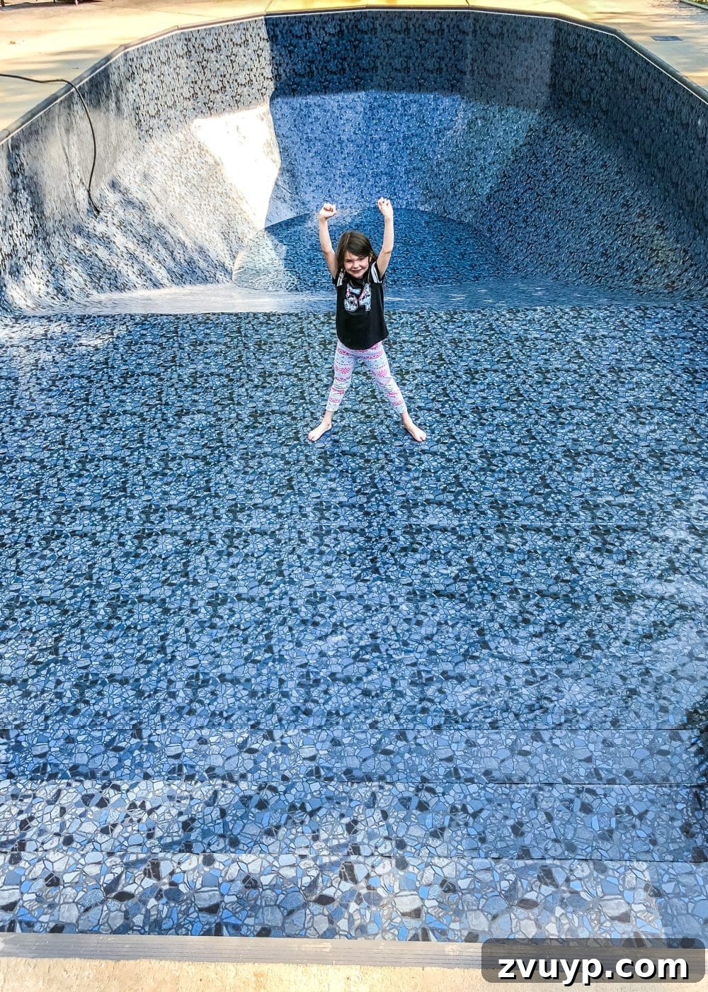 Our Pool's Stunning Liner Transformation 12 Swimming Pool Liner Makeover Reveal - child enjoying the new Obsidian pool liner from GLI Pool Products TrueStone Collection
