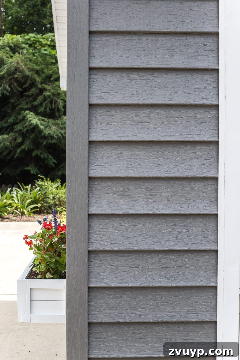 Refresh Your Exterior: Vinyl Siding Painting and Pool Shed Makeover 6 Finished pool shed exterior with newly painted dark gray vinyl siding, white trim, and decorative black shutters