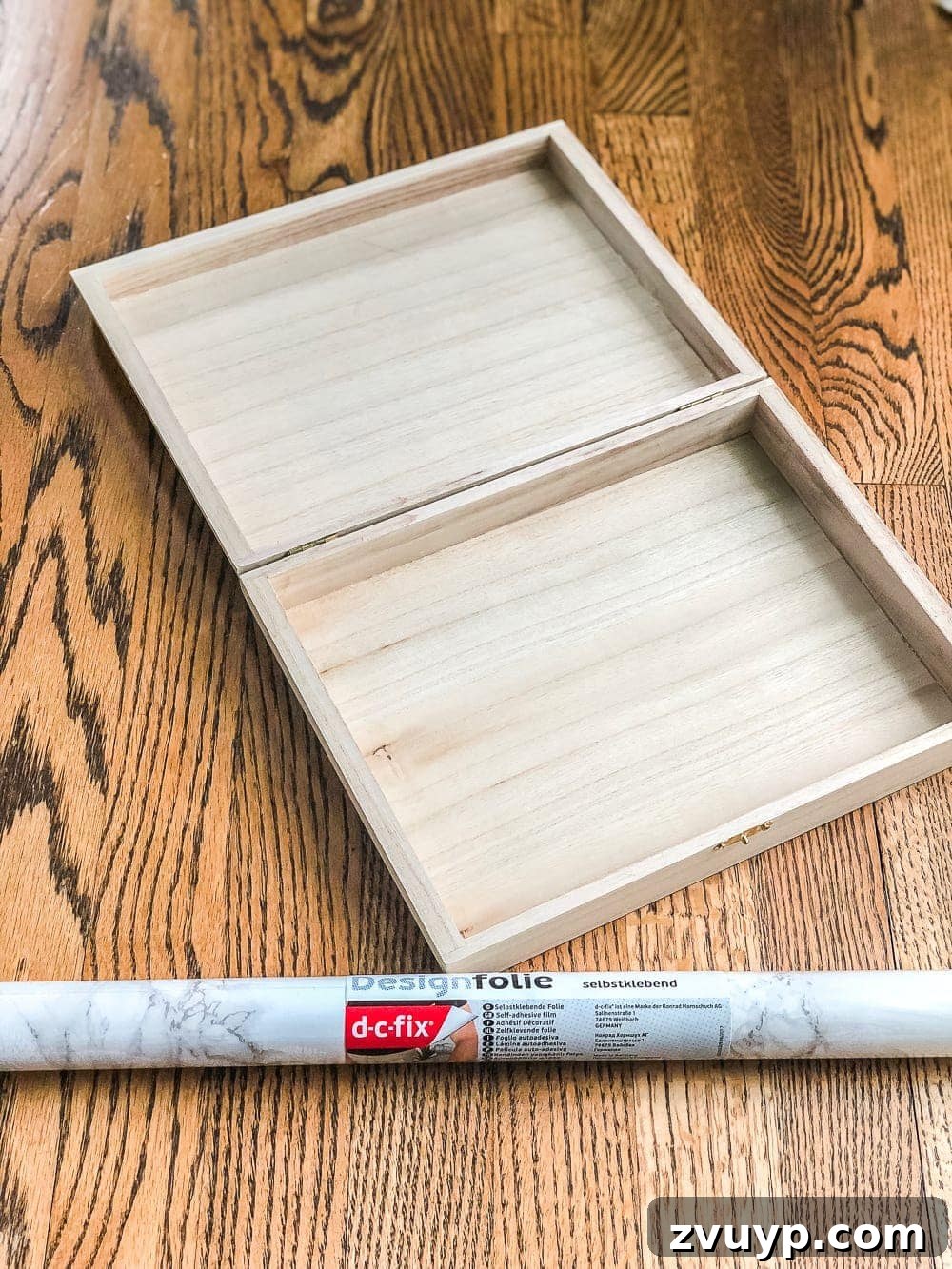 Cigar Box to Chic Faux Marble Remote Organizer 3 Unwrapped cigar box next to marble contact paper, ready for a DIY remote control holder transformation.