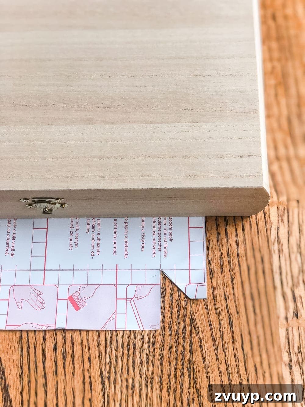 Cigar Box to Chic Faux Marble Remote Organizer 6 Contact paper with a corner flap cut, demonstrating how to prepare it for wrapping a box.