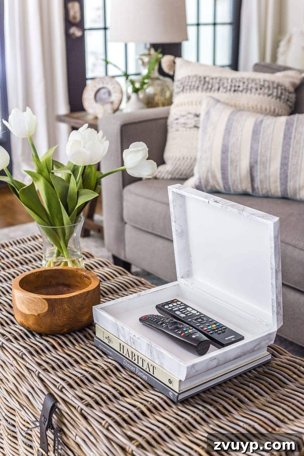 Cigar Box to Chic Faux Marble Remote Organizer 10 Stylish marble contact paper remote control holder sitting on a stack of decorative books on a coffee table.