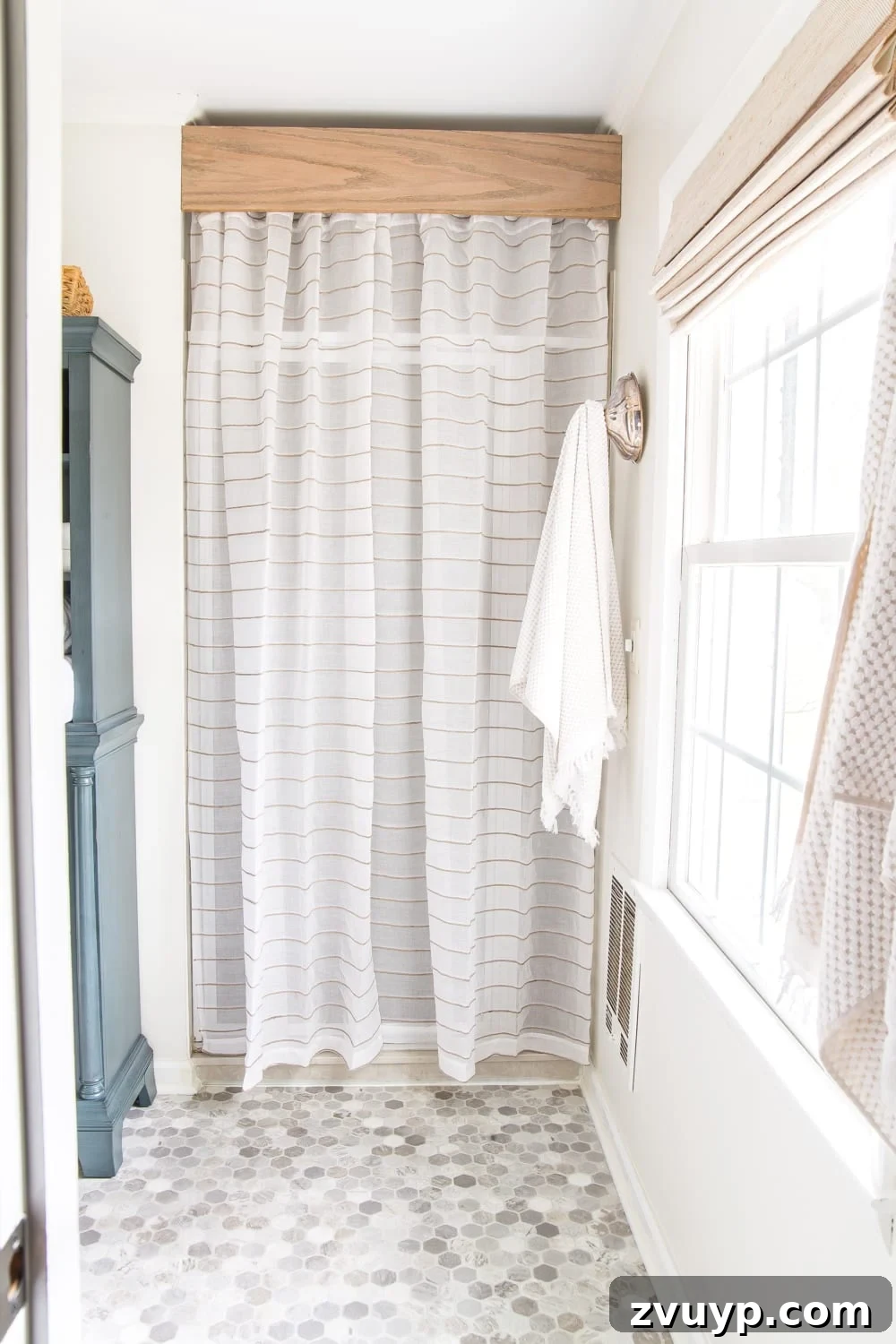 High Impact Room Updates on a Budget 8 Big Impact Ways to Redecorate a Room Inexpensively | shower curtain hiding old shower door