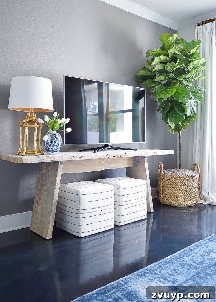 Beyond the Screen: Creative Ways to Style Your TV Area 16 Tall plant beside a TV to add visual height and distract from the screen's presence.