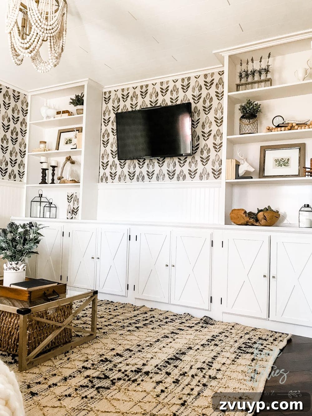 Beyond the Screen: Creative Ways to Style Your TV Area 17 Elegant wallpaper behind a TV, adding pattern and style to the entertainment area.