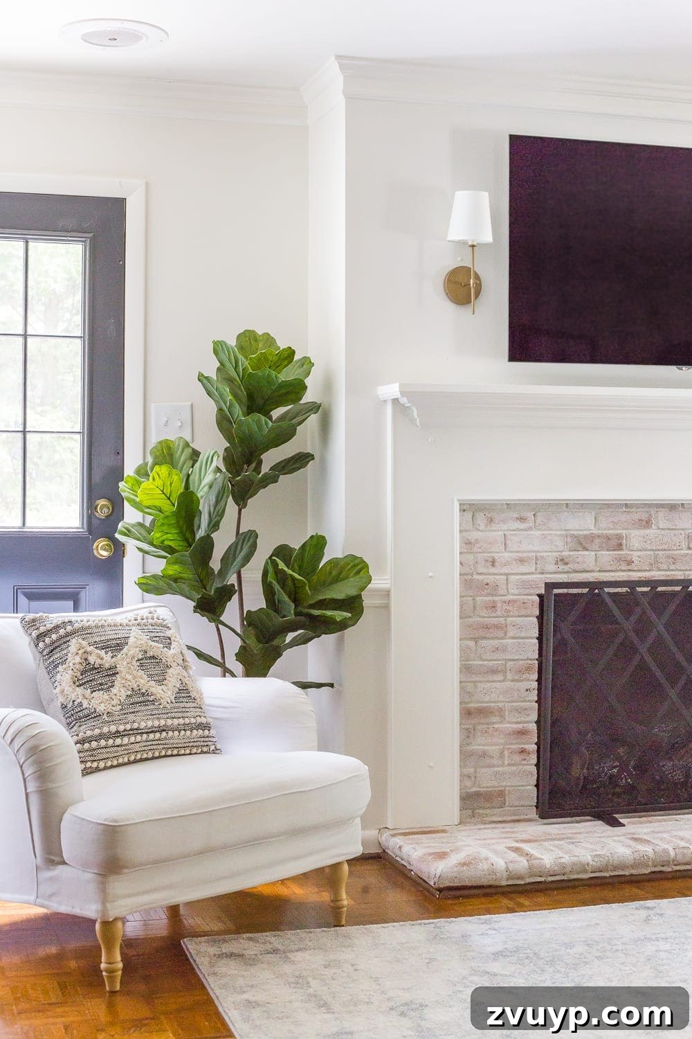 Beyond the Screen: Creative Ways to Style Your TV Area 5 Minimalist mantel design with sconces on either side of a TV, creating balanced decor.