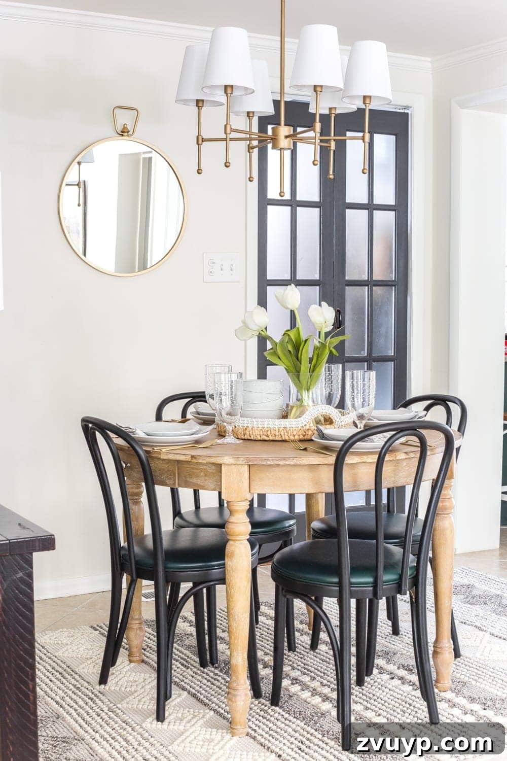 Breakfast Nook Glow Up 9 Gold round mirror and table lamp enhance a small breakfast nook's brightness and style.