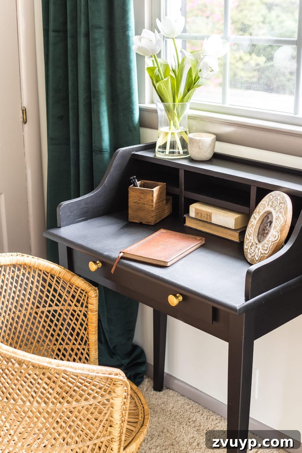 Giving an Old Writing Desk a New Story 5 Close-up of the vintage writing desk with aged brass knobs and rattan chair