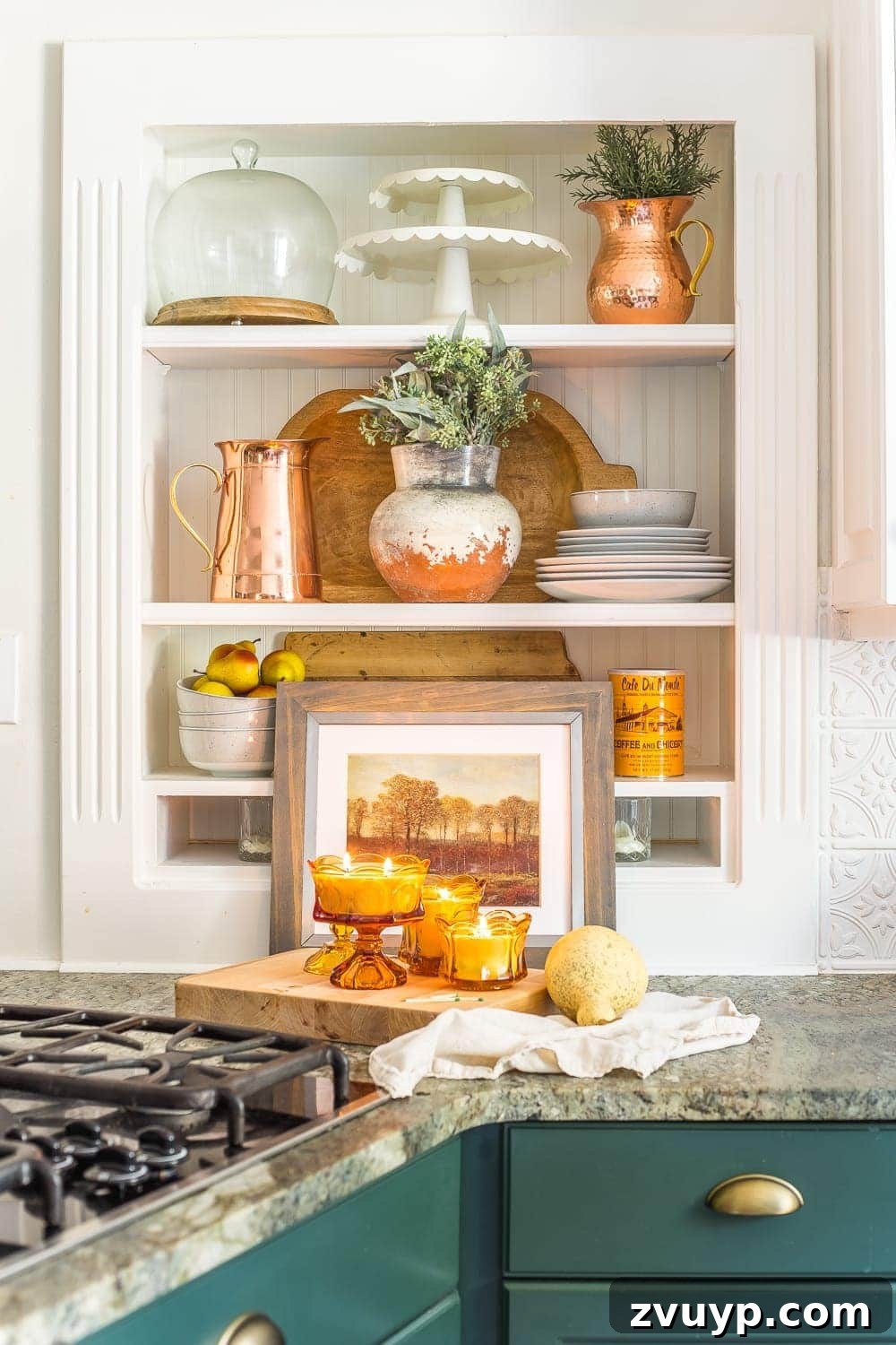 Sweet Dish Glow: DIY Candle Making 9 Kitchen shelves styled with copper pitchers, faux greenery, and DIY amber glass soy wax candles, creating a warm fall display.