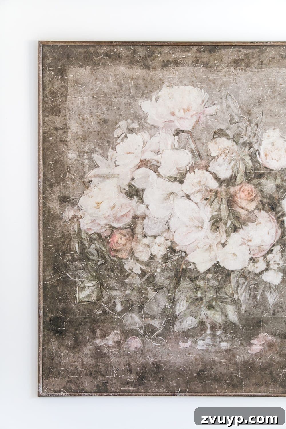 A boring guest bedroom gets a luxe, vintage chic makeover using thrifty projects, budget finds, and simple decorating tricks to maximize style and space. Large vintage-style art piece serving as the focal point in the guest bedroom.