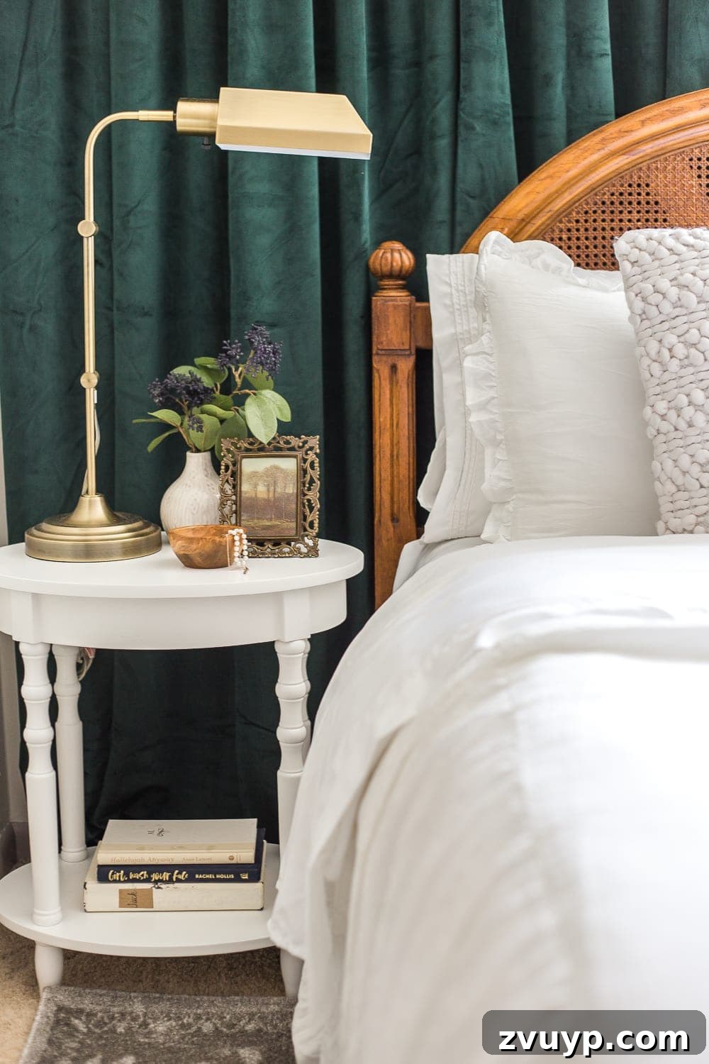 A boring guest bedroom gets a luxe, vintage chic makeover using thrifty projects, budget finds, and simple decorating tricks to maximize style and space. Deep green velvet curtains add a luxurious touch to the guest bedroom.