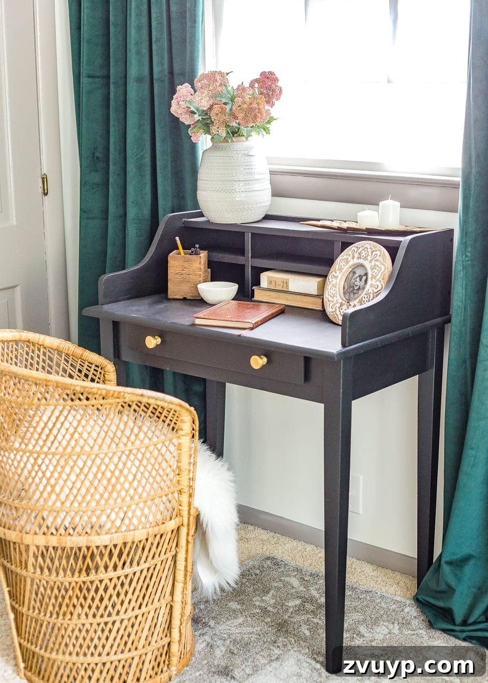 A boring guest bedroom gets a luxe, vintage chic makeover using thrifty projects, budget finds, and simple decorating tricks to maximize style and space. Close-up of the refurbished vintage desk with decor.