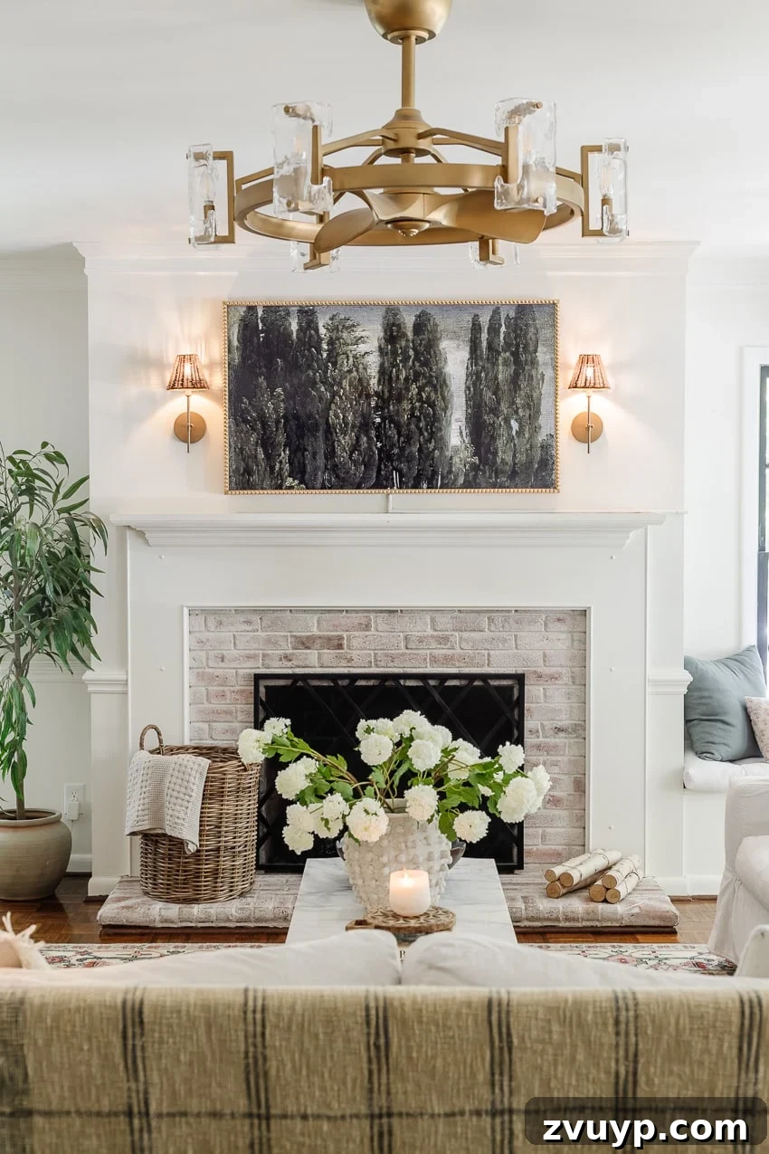 20 Handpicked Modern Ceiling Fans to Adorn Your Home 4 Limewashed brick fireplace anchors a stylish living room featuring a striking gold fandelier, creating a luxurious and comfortable atmosphere.