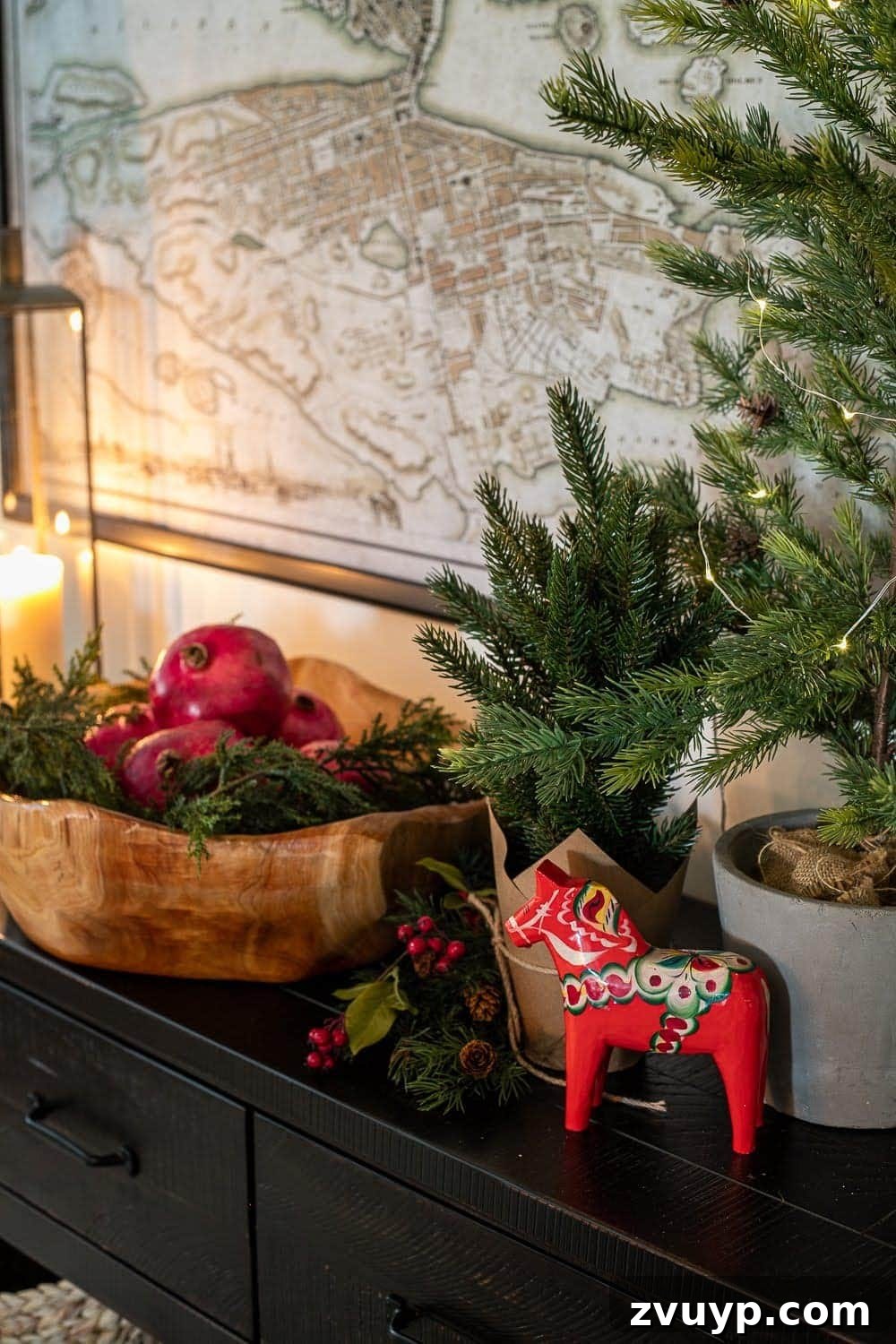 Weaving Past and Present: A Swedish Christmas Decor Story 12 A beautiful Swedish Christmas vignette with warm candlelight, a cherished Dala horse, a bowl of pomegranates, lush greenery, and twinkling fairy lights, embodying the cozy hygge aesthetic.