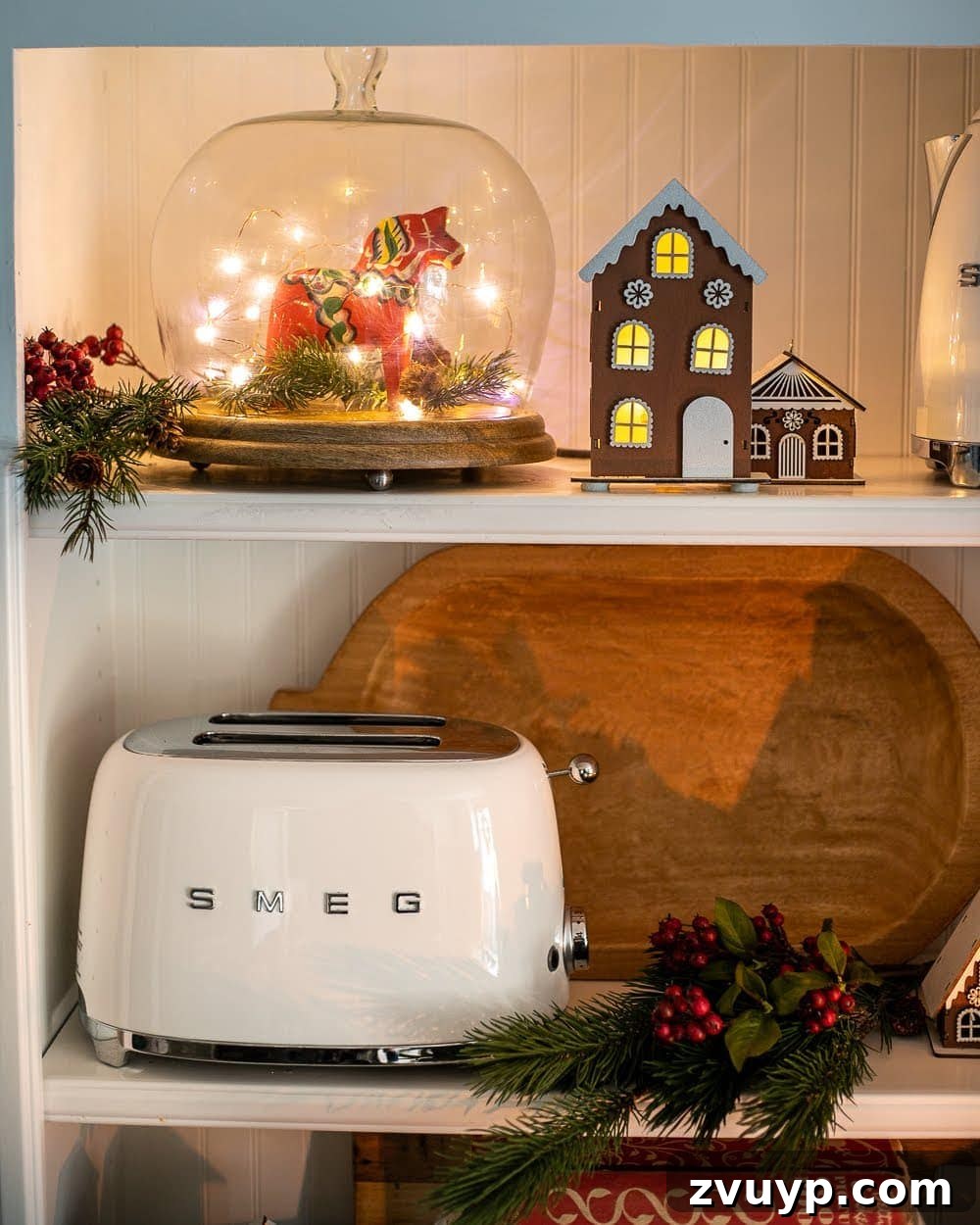 Weaving Past and Present: A Swedish Christmas Decor Story 6 Styled kitchen shelves featuring a Dala horse under a cloche with fairy lights, surrounded by gingerbread cookies, green accents, and other Swedish Christmas decor elements.