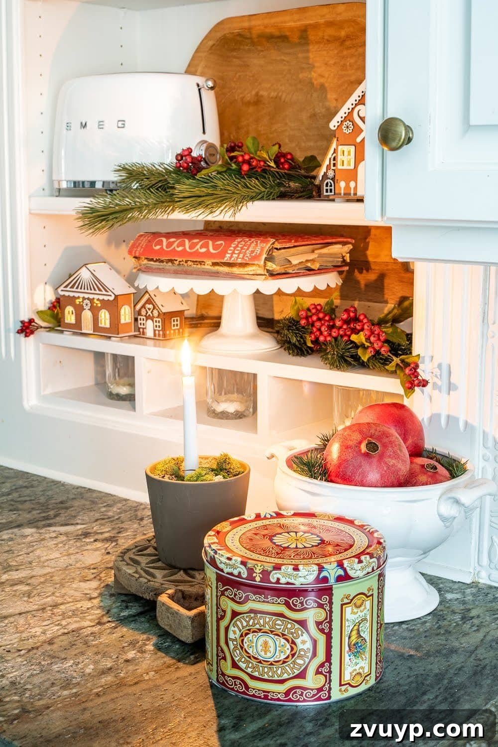 Weaving Past and Present: A Swedish Christmas Decor Story 7 A festive display on kitchen shelves with an old cookbook, illuminated wooden houses, and natural wooden cutting boards, embodying a cozy Swedish Christmas style.