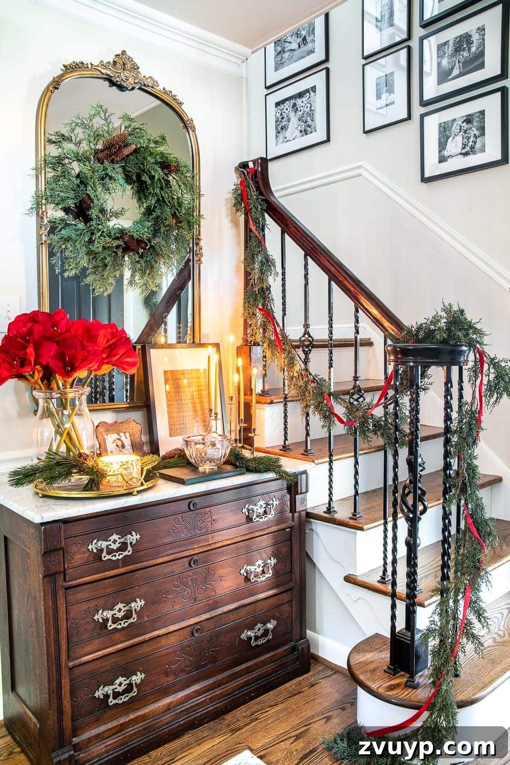 Festive Home Tour 4 Christmas decor ideas: A modern meets traditional Christmas foyer with elegant red amaryllis and realistic faux garland, creating a warm and festive welcome.