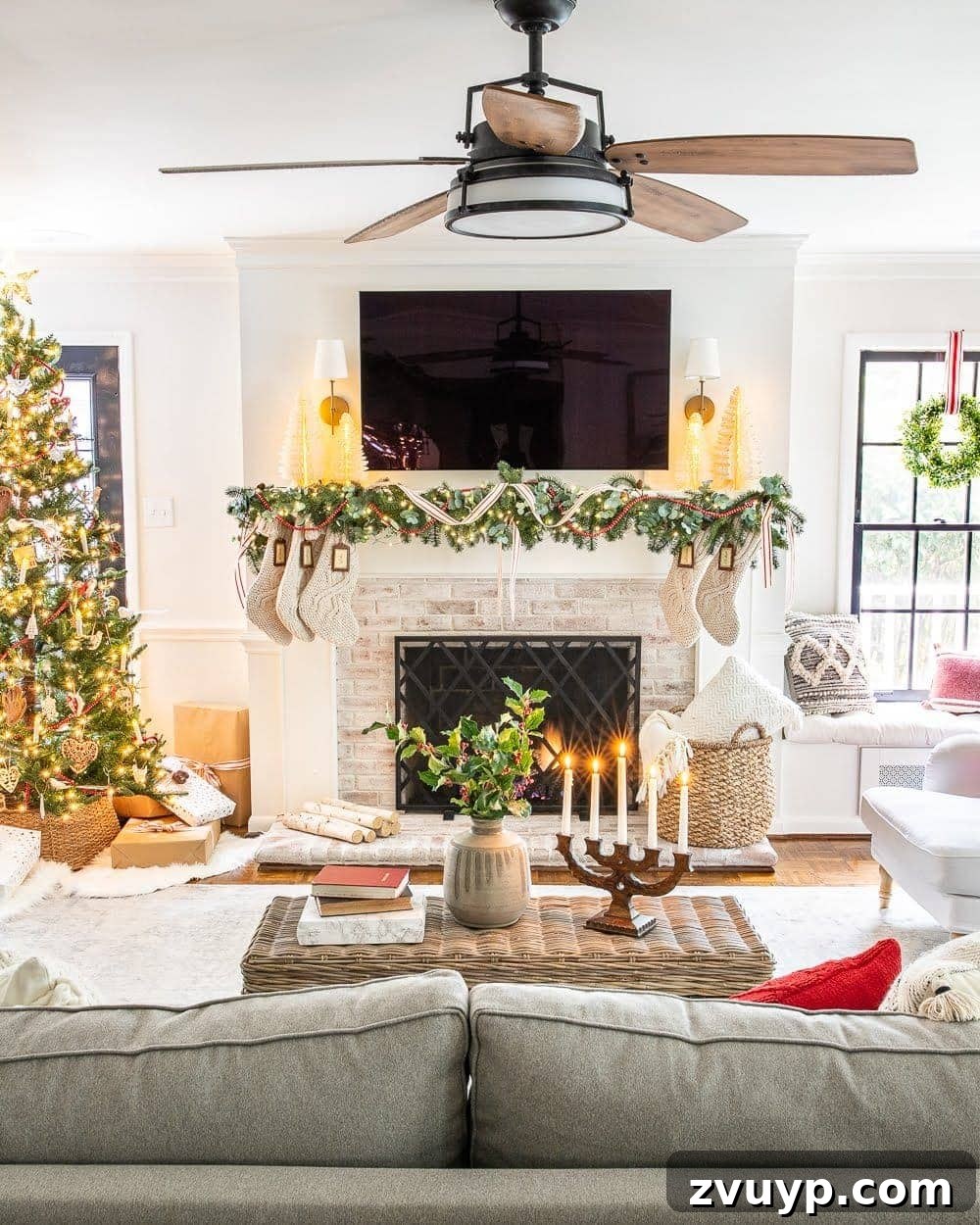 Festive Home Tour 27 Christmas decor ideas: A festive Christmas mantel with a TV, showcasing beautiful holiday decorations and a cozy living room ambiance for the holidays.