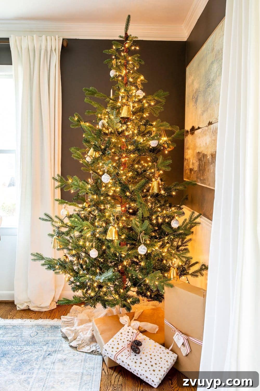 Festive Home Tour 8 Christmas decor ideas: A beautifully decorated Christmas tree takes center stage in the dining room, adding festive charm and warmth to the space.