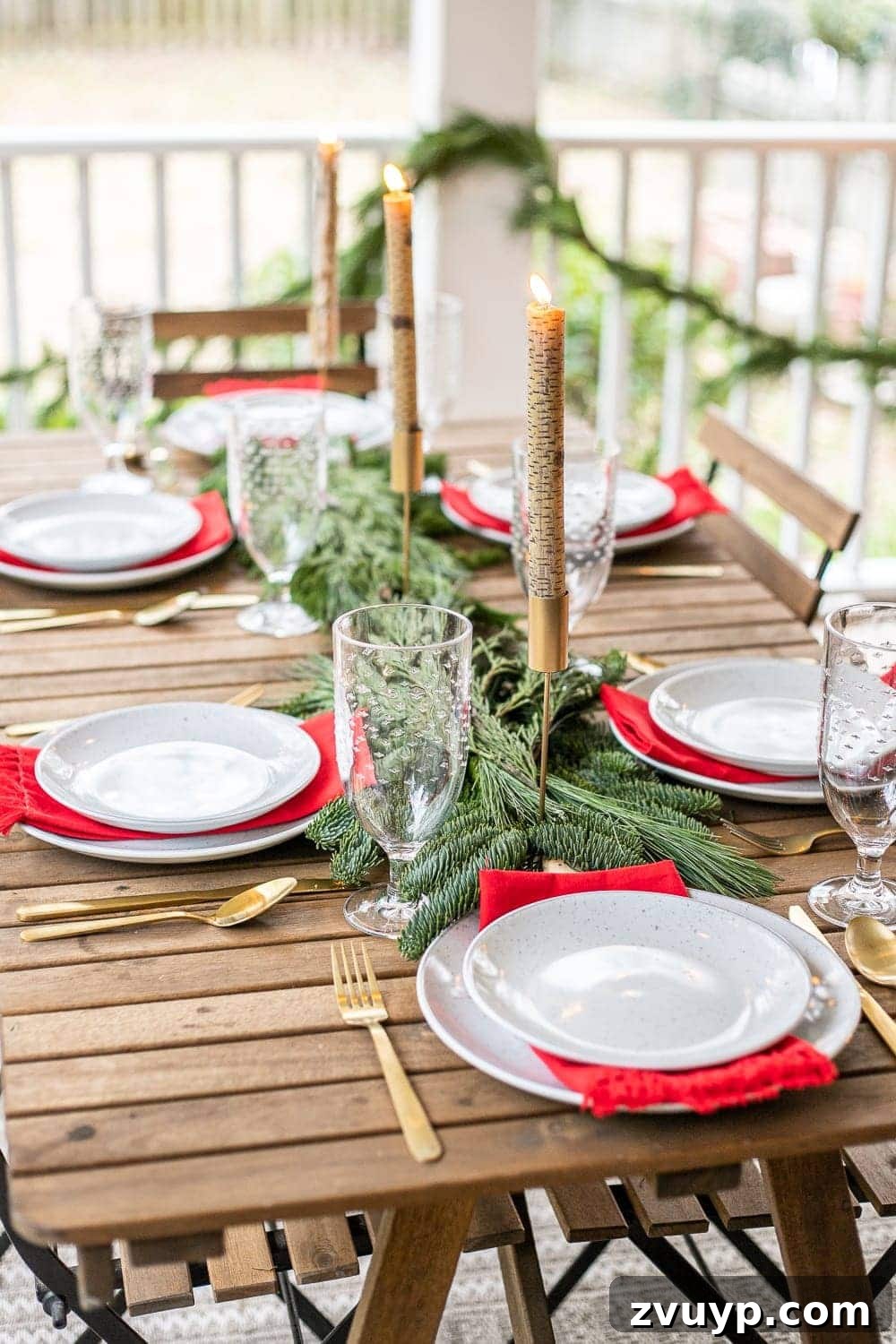 Warm Yuletide Veranda 11 Elegant Christmas outdoor tablescape adorned with fresh greenery and charming birch candles