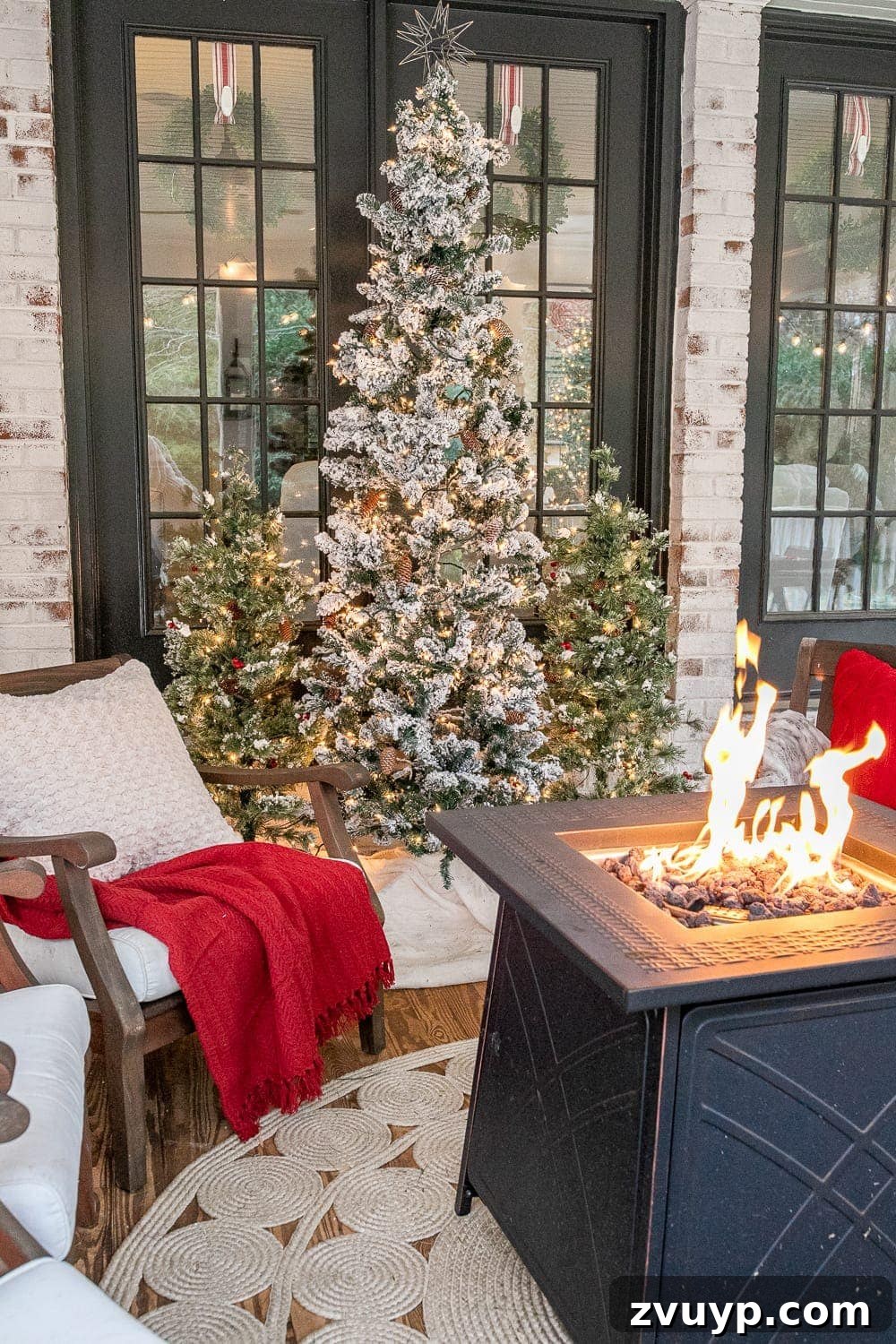 Warm Yuletide Veranda 9 Back porch featuring a stylish fire pit table and festive Christmas trees