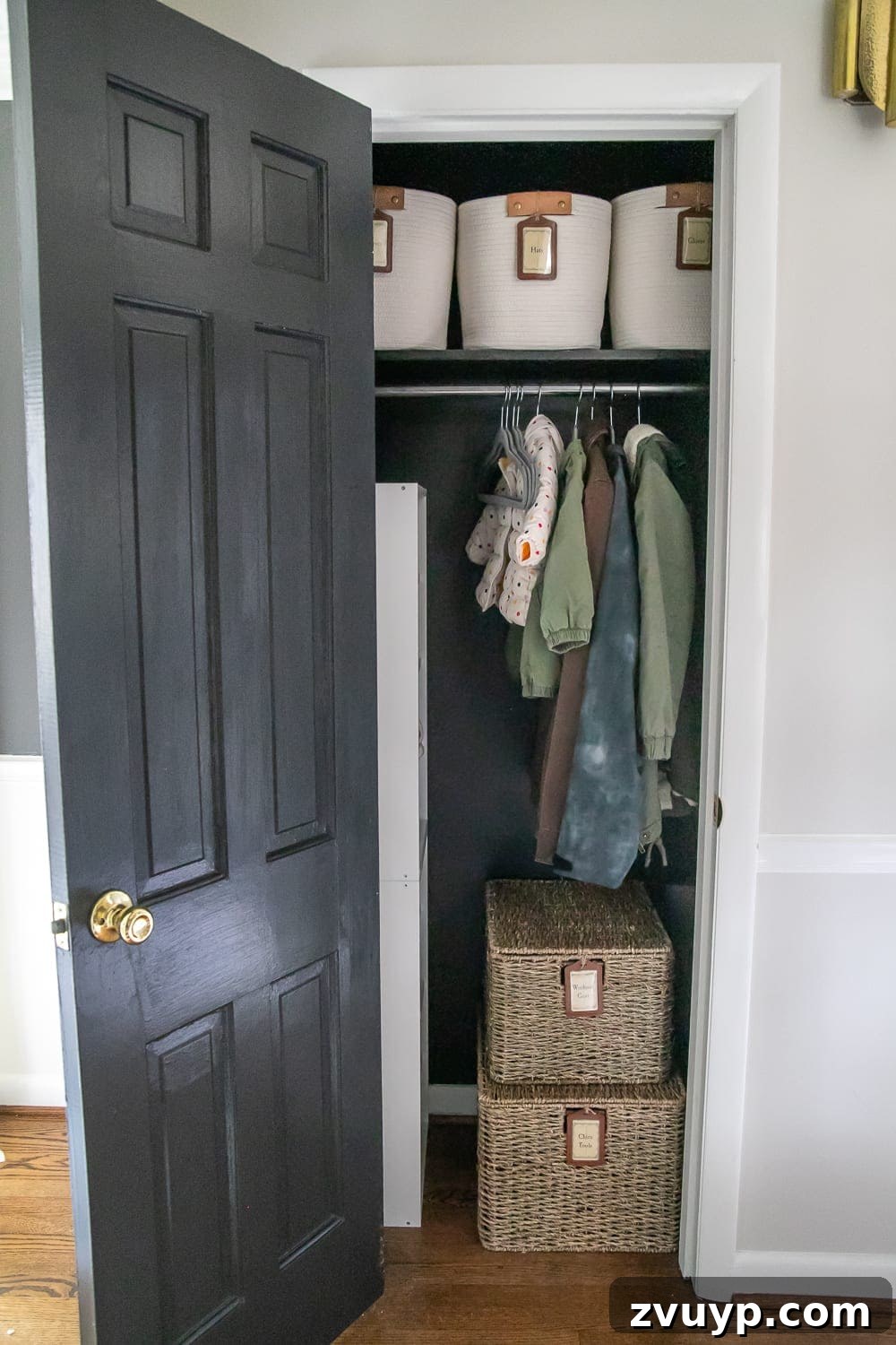 Smart Coat Closet Organization 4 Neatly organized coat closet after transformation, featuring baskets, labeled storage, and matching hangers.