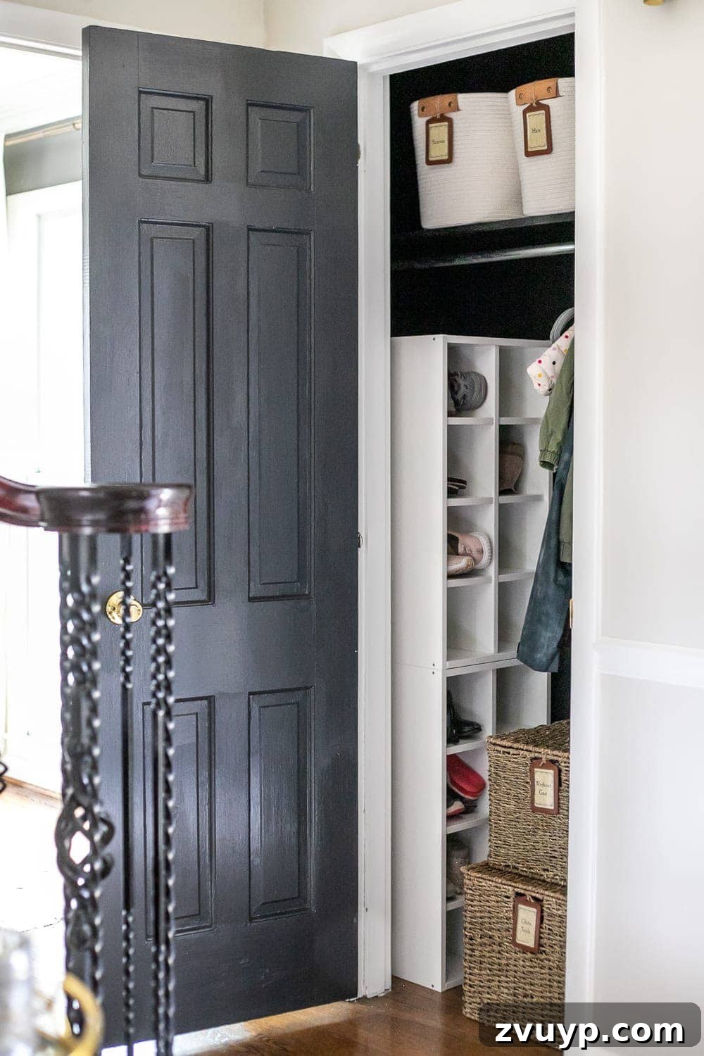 Smart Coat Closet Organization 7 Organized coat closet featuring a shoe storage unit, fabric bins for accessories, and hanging coats, creating a tidy entryway.