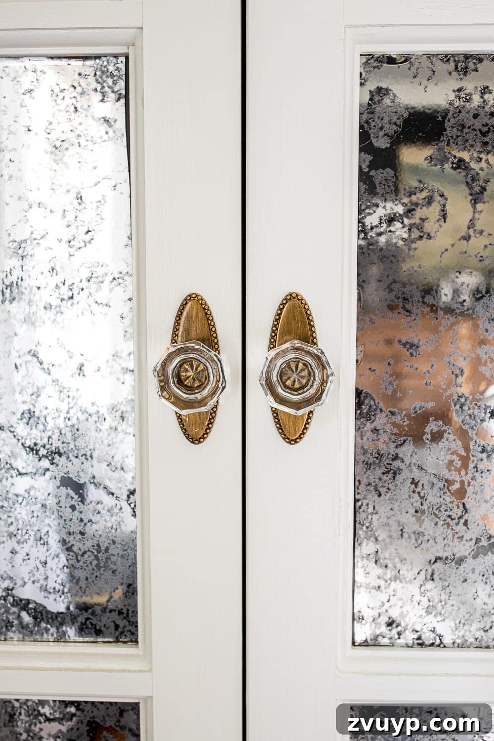 A Masterpiece in Mood: Our Modern Vintage Master Bedroom Unveiled 12 Close-up of antique style gold and glass knobs on French bifold closet doors in a refreshed master bedroom.