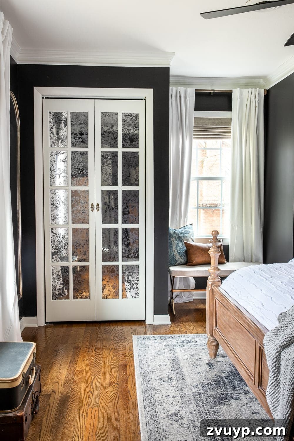 A Masterpiece in Mood: Our Modern Vintage Master Bedroom Unveiled 13 Black master bedroom showcasing elegant white velvet curtains, woven Roman shades, and French bifold closet doors.