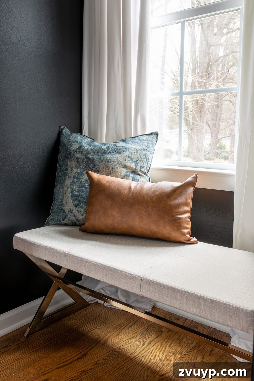 A Masterpiece in Mood: Our Modern Vintage Master Bedroom Unveiled 14 Master bedroom with a comfortable bench placed under a window, serving as a functional window seat and dressing area.