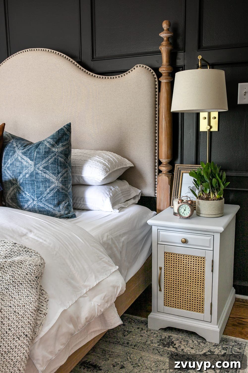 A Masterpiece in Mood: Our Modern Vintage Master Bedroom Unveiled 8 Refreshed nightstand with cane webbing and a grid molding focal wall in a moody black master bedroom.