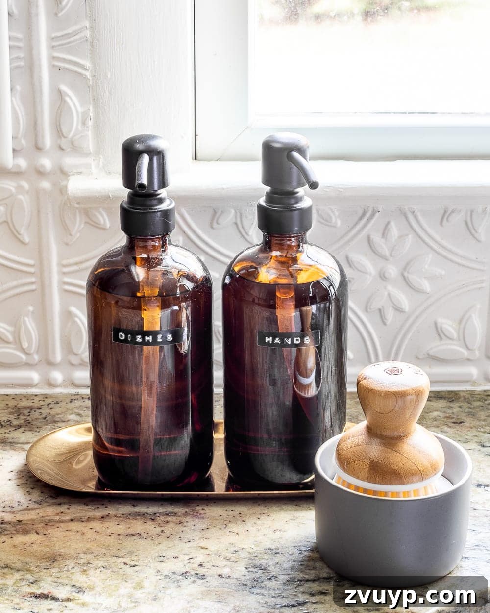 Stylish Kitchen Counters Made Simple 9 Hand soap and dish soap in stylish dispensers on a tray by the kitchen sink