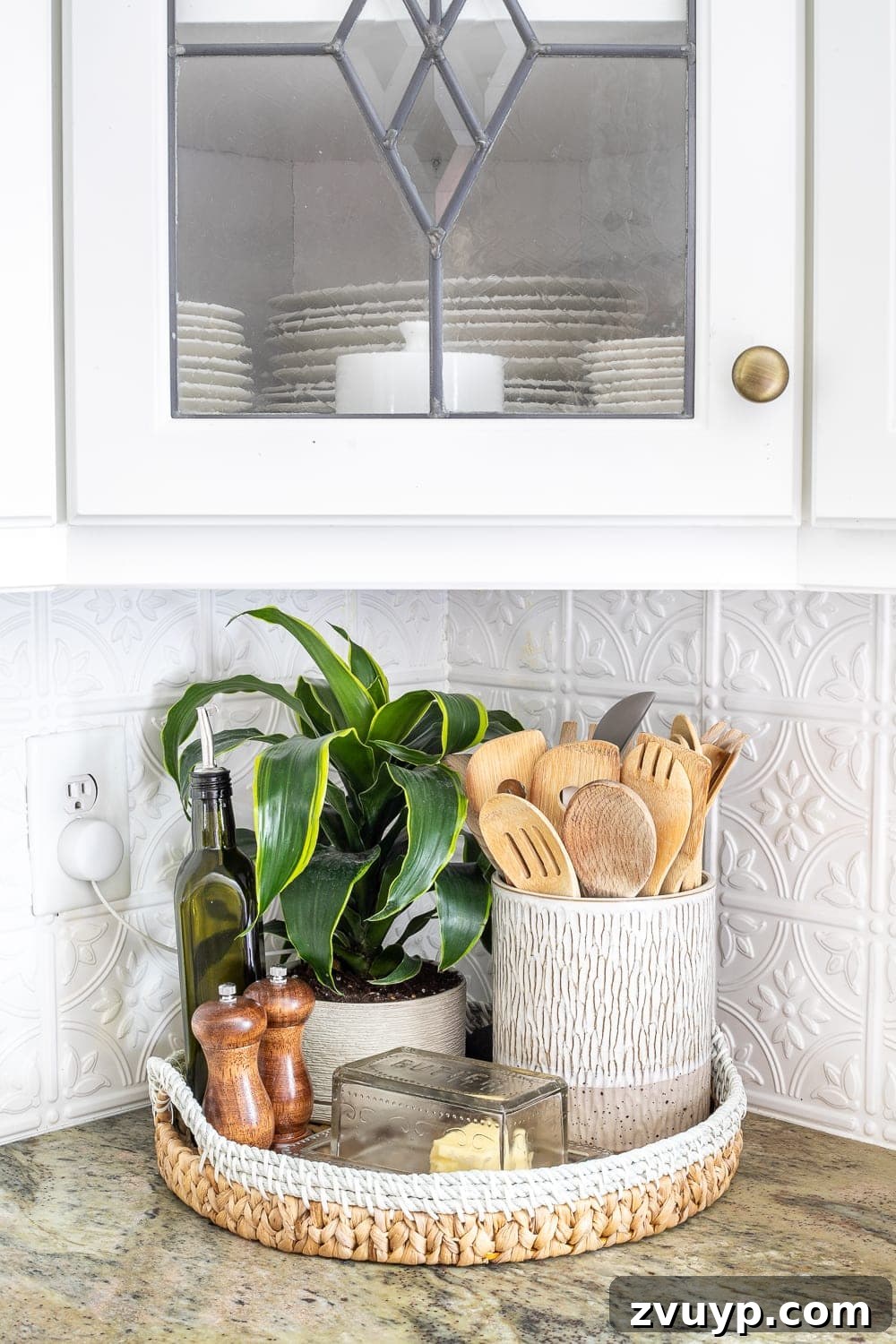 Stylish Kitchen Counters Made Simple 7 Kitchen tray with cooking utensils, olive oil, butter dish, salt and pepper grinders, and a plant
