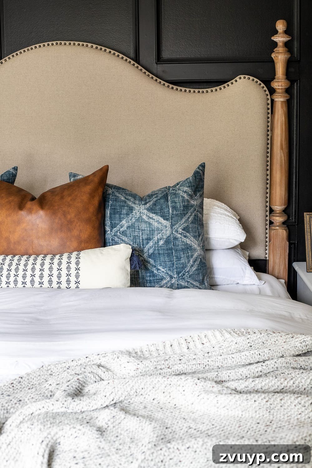 Clever Hacks for a Cloud-Like Bed on a Budget 2 Linen and wood headboard with throw pillows and fluffy bedding, showcasing a well-styled bed.