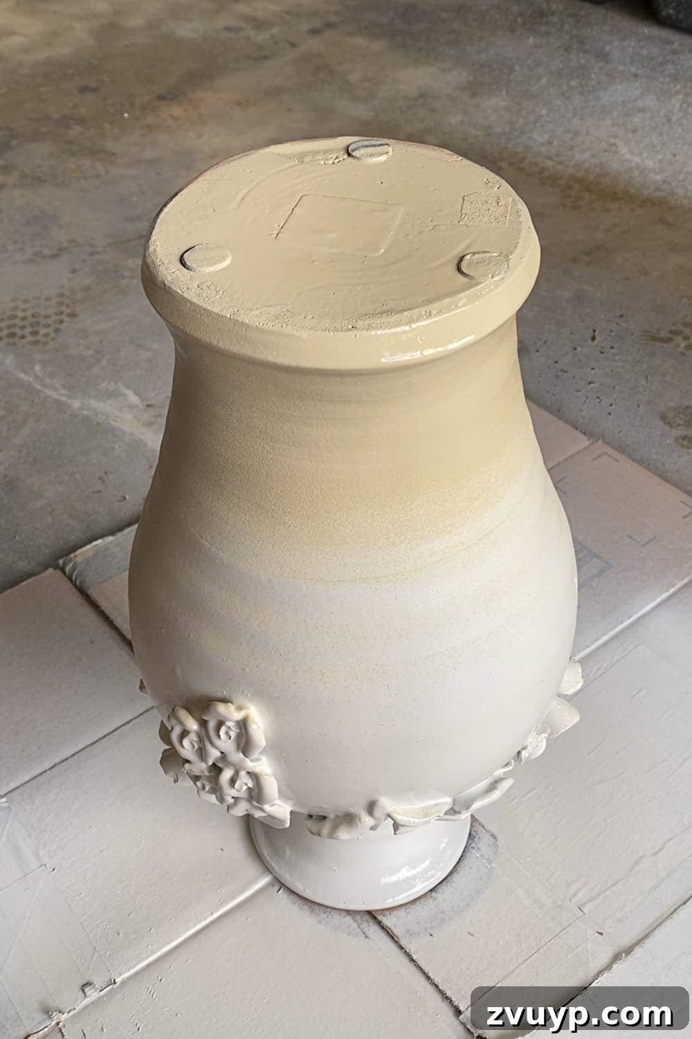 From Knock-Off to Showpiece: Ceramic Bloom Vase Transformation 4 Creating an ombre effect on ceramic with spray paint, blending white and beige for a soft gradient.